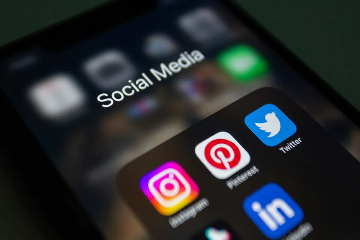 A close-up of a cell phone screen that has Social Media icons on.