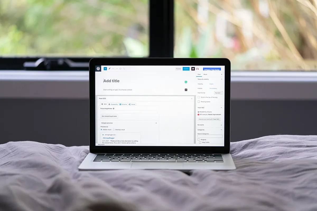 An open laptop on a bed.
