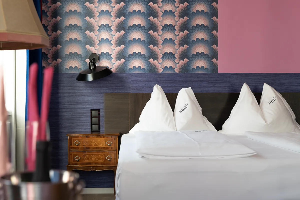 A beautiful hotel room with details in pink and purple.