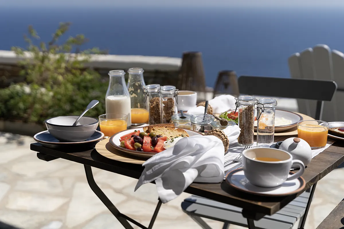 A table set for breakfast with spectacular sea views. The setup of the table by the photographer shows the importance of professional hotel photography.